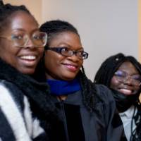 3 women smile for camera